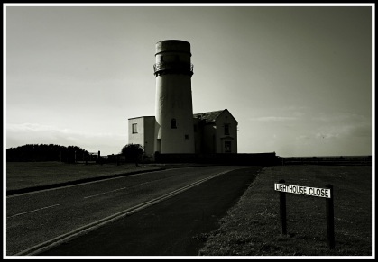 photo taken at the start of lighthouse close with the sign on the lower right and the lighthouse in the centre of the photo
