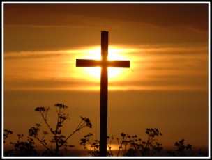The sun is directly behind a large centred cross, and the sun is located beautifully on the intersection of the cross