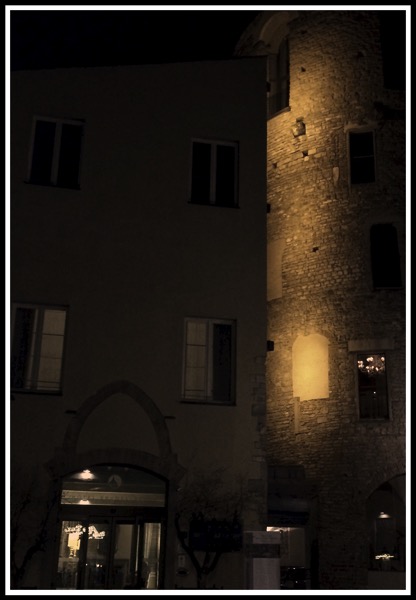 A sepia effect of hotel Brunelleschi at night with the old tower glowing out in the dark