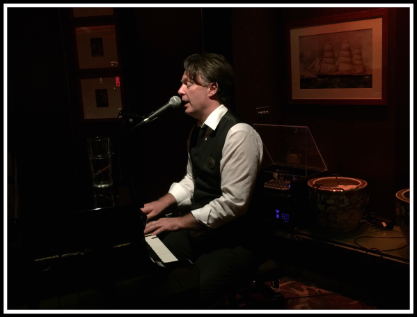 Alan Davidson playing piano and singing in Delo bar