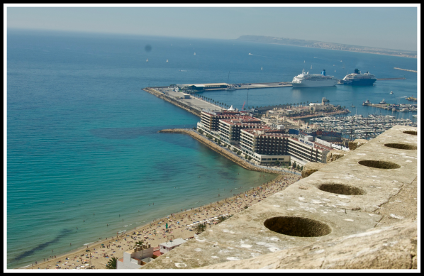 A view looking out from the top of the castle down onto the coastline of Alicante