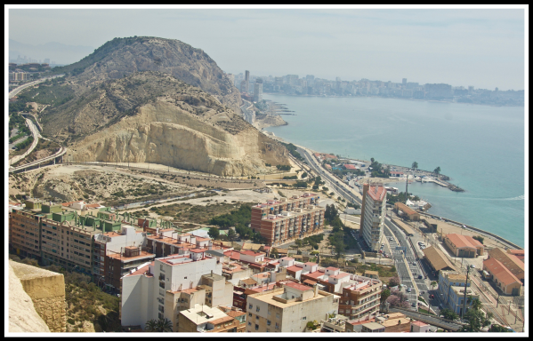A view looking out from the top of the castle down onto the coastline of Alicante